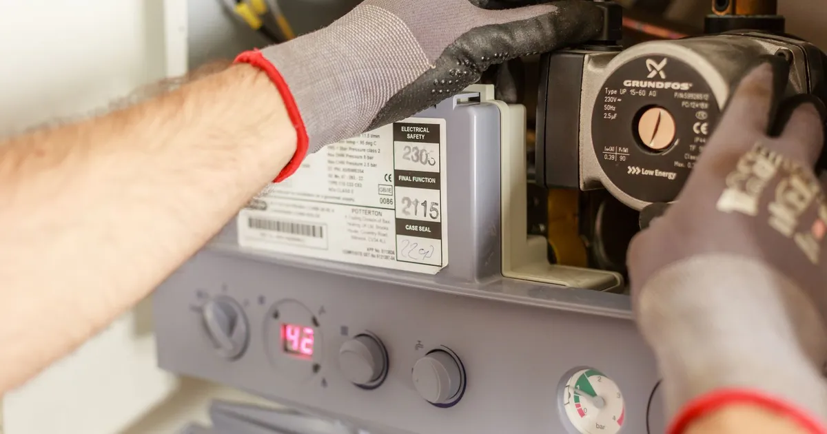 Elektriker arbeitet an der Regelung und Umwälzpumpe einer Heizungsanlage im Technikraum, Ratgeber von Rucker Elektro München