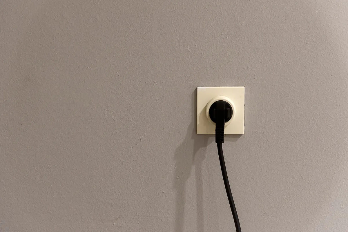 Schuko-Steckdose mit eingestecktem Kabel an einer Wand, Elektroinstallation in Waldtrudering, Rucker Elektro München