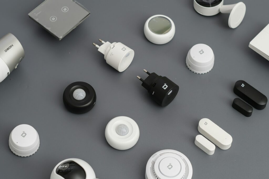 Diverses Smart-Home-Zubehör von Deon – Bewegungsmelder, Steckdosen, Tür- und Fenstersensoren in Schwarz und Weiß